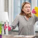 Housewife wearing gloves having sensitivity to cleaning detergents