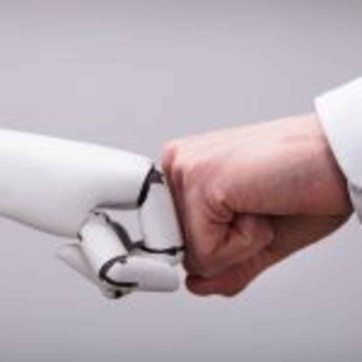 Robot And Human Hand Making Fist Bump