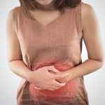 The Photo Of Large Intestine Is On The Woman’s Body. People With Stomach Ache Problem Concept. Female Anatomy