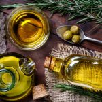 Top view of olives and olive oil bottles on table in a rustic kitchen