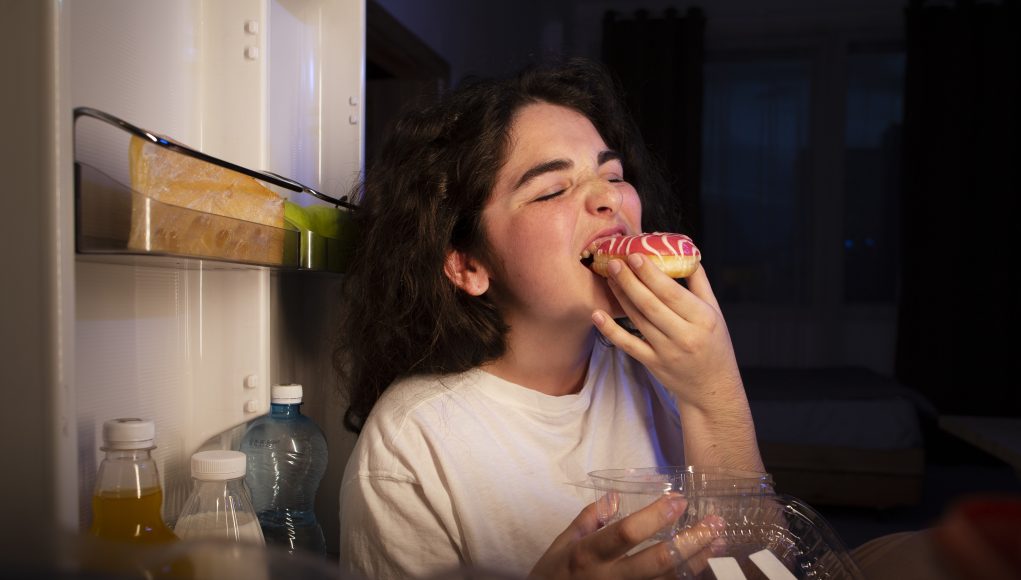 side-view-woman-eating-doughnut