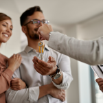 closeup-real-estate-agent-giving-couple-keys-their-new-home