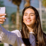 cheerful-brunette-with-wide-smile-doing-selfie