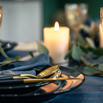 table-setting-with-textured-wine-glasses-candles-leaves