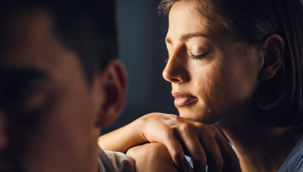 Young woman feeling sad and crying.