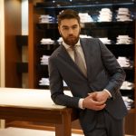 Man in suit standing near the table  shop
