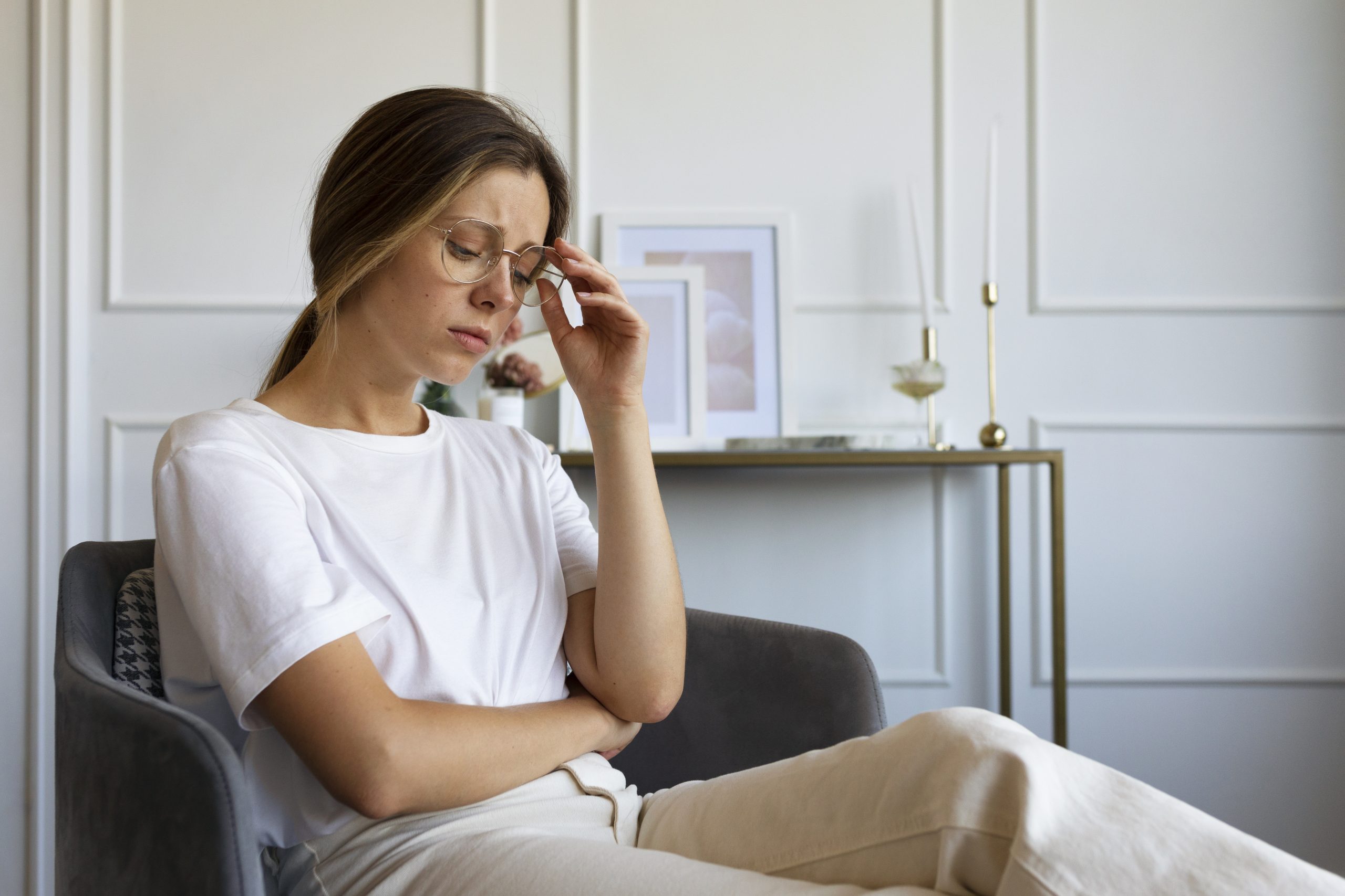 side-view-anxious-woman-sitting-chair